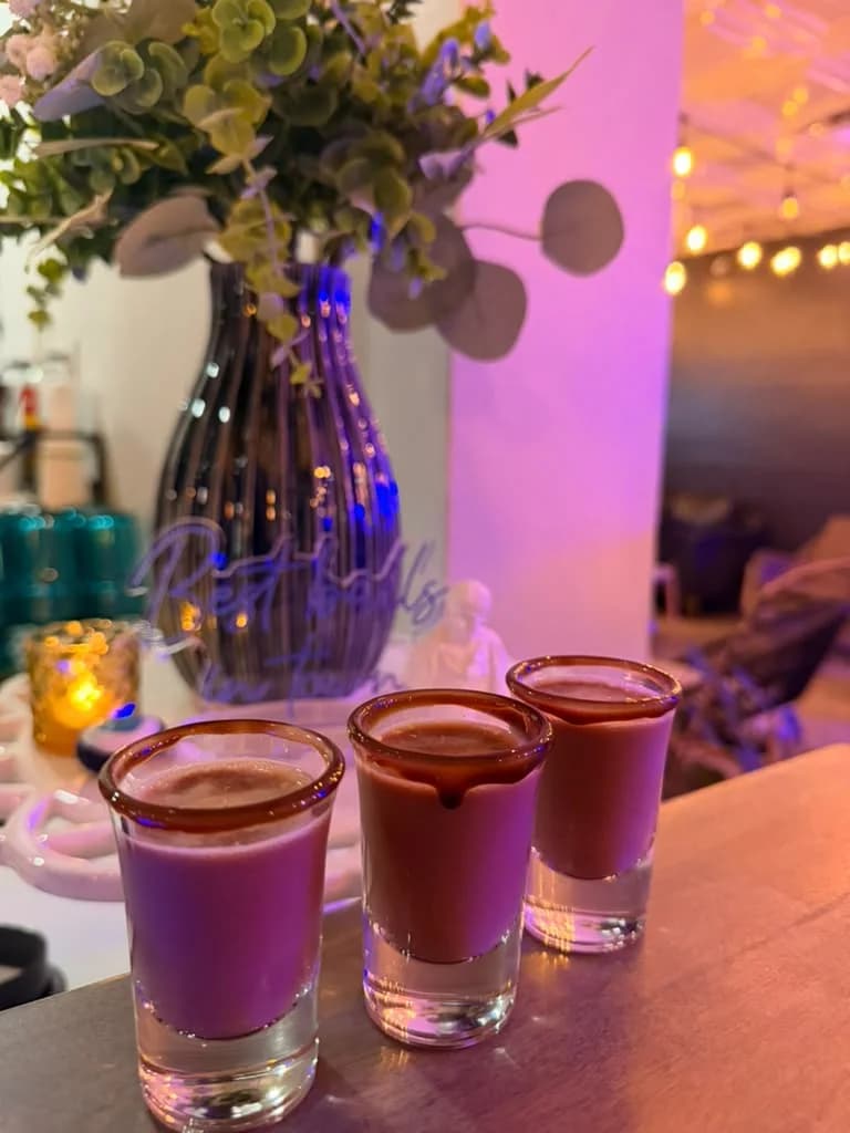 Three purple botanical shots at the Zeus Greek bar