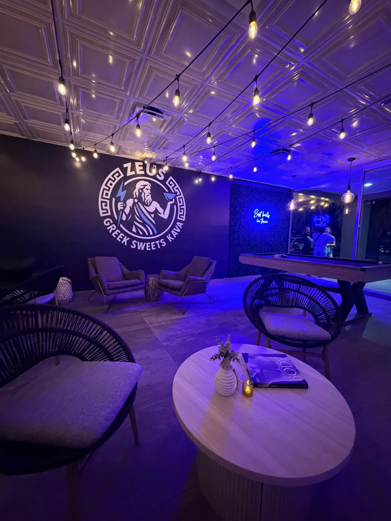 Zeus Greek lounge with blue evening lighting in Pompano Beach