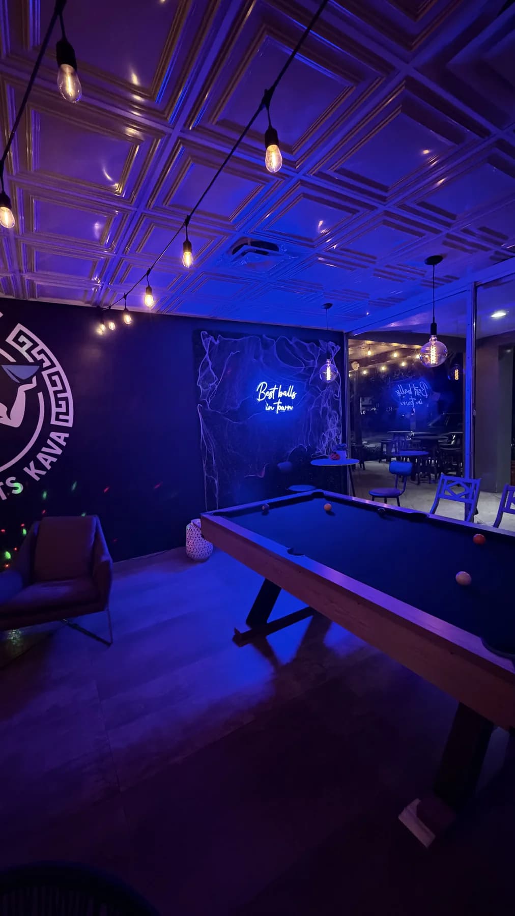 Pool table, string lights and Zeus wall mural inside the Pompano Beach lounge